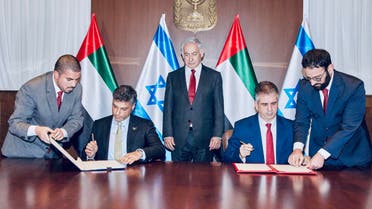 UAE's ambassador to Israel Mohamed Al Khaja and Israeli Foreign Minister Eli Cohen sign a free trade pact into effect, in the presence of Israel's Prime Minister Benjamin Netanyahu. (Twitter/AmbAlKhaja)