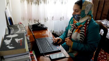 Sana, an Afghan teacher, teaches during an online class, at her house in Kabul, Afghanistan, February 28, 2023. (Reuters)