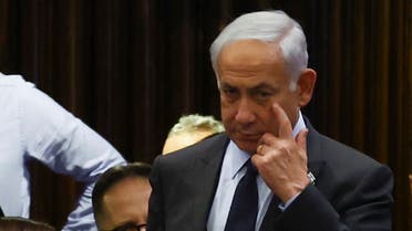 Israeli Prime Minister Benjamin Netanyahu gestures as he attends a meeting at the Knesset, Israel's parliament, amid demonstrations after he dismissed the defence minister as his nationalist coalition government presses on with its judicial overhaul, in Jerusalem, March 27, 2023. (Reuters)