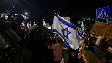 People attend a demonstration after Israeli Prime Minister Benjamin Netanyahu dismissed the defense minister and his nationalist coalition government presses on with its judicial overhaul, in Jerusalem, March 26, 2023. (Reuters)