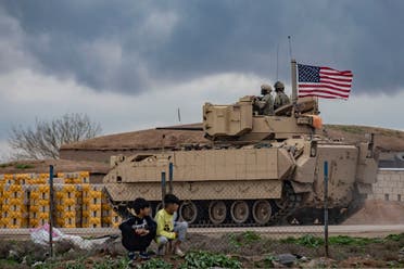 A US armored military vehicle drives on the outskirts of Rumaylan in Syria's northeastern Hasakeh province, bordering Turkey, on March 27, 2023. (AFP)