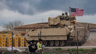 A US armored military vehicle drives on the outskirts of Rumaylan in Syria's northeastern Hasakeh province, bordering Turkey, on March 27, 2023. (AFP)