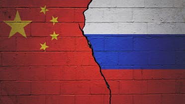 China and Russia relationships background. Country flags painted on cracked concrete walls stock photo