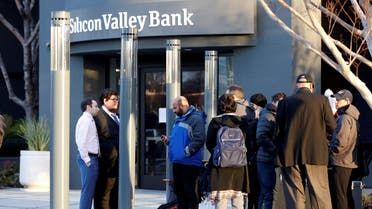 FDIC representatives Luis Mayorga and Igor Fayermark speak with customers outside of the Silicon Valley Bank headquarters in Santa Clara, California, US March 13, 2023. (Reuters)