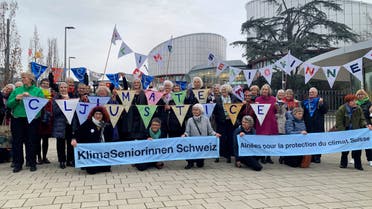 A group from the Senior Women for Climate Protection association hold banners outside the European Court of Human Rights in Strasbourg, France March 29, 2023. (Reuters)