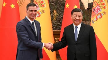 This handout taken and received from La Moncloa on March 31, 2023 shows Spain’s Prime Minister Pedro Sanchez (L) shaking hands with Chinese President Xi Jinping (R) in Beijing. (AFP)