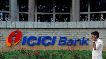 A pedestrian walks past a logo of ICICI Bank at its headquarters in Mumbai January 30, 2015. (Reuters)