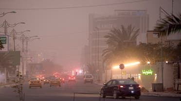 Vehicles drive down a road in Baghdad as thick dust blankets the city, on March 31, 2023. A sandstorm enveloped central Iraq, including Baghdad on March 31, the first such weather event to hit the arid country this year, after it experienced in 2022 an unprecedented number of sandstorms, which was attributed to desertification. AFP