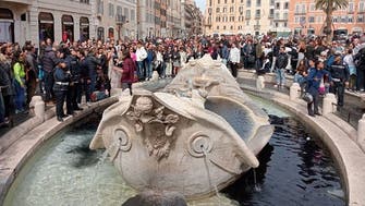 Climate activists turn landmark Rome fountain black      