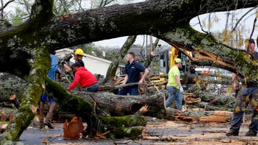 Sherwood, Ark. Police and firefighters get help from volunteers clearing downed trees on Keihl Avenue after storms ripped through the area, Friday, March 31, 2023, in Sherwood, Ark. A monster storm system tore through the South and Midwest on Friday, spawning tornadoes that shredded homes and shopping centers, overturned vehicles and uprooted trees as people raced for shelter. (Thomas Metthe/Arkansas Democrat-Gazette via AP)