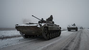 Ukrainian BMP-2 infantry combat vehicles drive in a convoy down an icy road in the Donetsk region on January 30, 2023, amid the Russian invasion of Ukraine. (AFP)