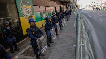 South African Police Service (SAPS) members line up to guard Luthuli House, the headquarters of the ruling African National Congress (ANC) party, ahead of their disgruntled supporter’s march in Johannesburg Central Business District on July 15, 2022. 
