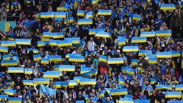 Ukraine supporters hold up flags during the anthems ahead of the UEFA Euro 2024 group C qualification football match between England and Ukraine at Wembley Stadium in London on March 26, 2023. (Photo by JUSTIN TALLIS / AFP)