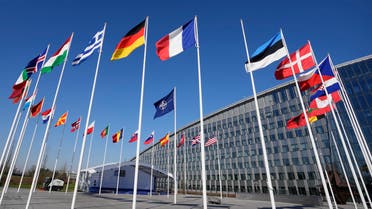 An empty flagpole stands between the national flags of France and Estonia outside NATO headquarters in Brussels, Monday, April 3, 2023. Finland awaits an official green light to become the 31st member of the world's biggest security alliance as NATO foreign ministers prepare to meet in Brussels on Tuesday and Wednesday. (AP Photo/Virginia Mayo)