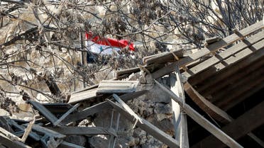 A Syrian national flag is seen through the rubble in the aftermath of an Israeli air strike that hit the medieval Citadel of Damascus on February 19, 2023. (File photo: AFP)