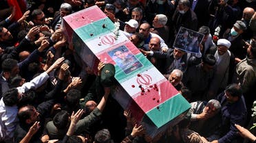 Mourners attend the funeral procession for two Iranian IRGC officers killed by Israel in Syria, held in Tehran on April 4, 2023. (AFP)