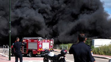 Israeli policemen stand next to smoke from a fire following incoming rockets from Lebanon to Israel in Bezet, northern Israel April 6, 2023. (Reuters)