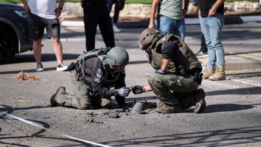 Israeli security personnel check the remains of a rocket in Shlomi, northern Israel on April 6, 2023. (Reuters)