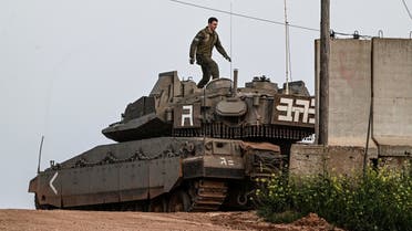 An Israeli soldier walks on top of a tank near Shtula, by the Israel Lebanon border, in northern Israel April 6, 2023. (Reuters)