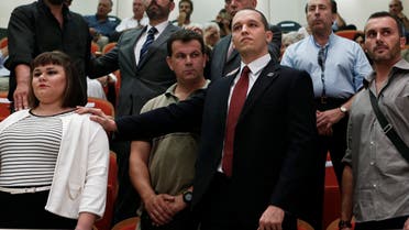 Far-right Golden Dawn lawmaker Ilias Kasidiaris (2nd R, front), who is in custody pending trial, attends the Athens council swearing-in ceremony August 29, 2014. (Reuters)