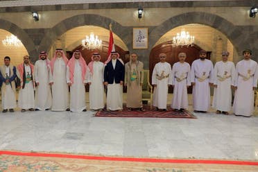 A handout picture released by the Houthi-affiliated branch of the Yemeni News Agency SABA on April 9, 2023, shows the Houthi group’s political leader Mahdi al-Mashat (6th R) posing for a picture with the Saudi ambassador to Yemen Mohammed Al Jaber (7th L) and a delegation, alongside an Omani delegation in Sanaa. (AFP)