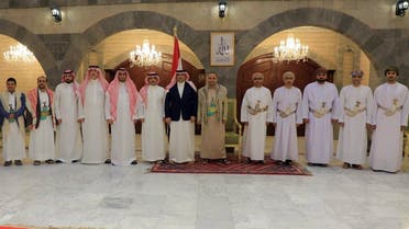 A handout picture released by the Houthi-affiliated branch of the Yemeni News Agency SABA on April 9, 2023, shows the Houthi group’s political leader Mahdi al-Mashat (6th R) posing for a picture with the Saudi ambassador to Yemen Mohammed Al Jaber (7th L) and a delegation, alongside an Omani delegation in Sanaa. (AFP)