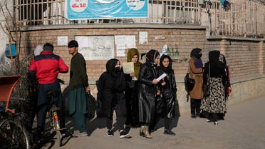 FILE - Afghan women students stand outside the Kabul University in Kabul, Afghanistan, on Dec. 21, 2022. The United Nations' human rights chief on Tuesday Dec. 27, 2022 decried increasing restrictions on women's rights in