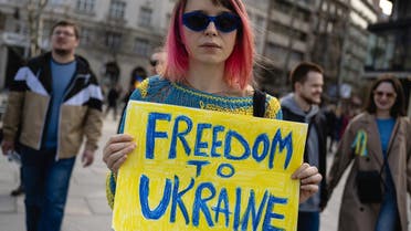 A protester holds a placard during a “March of Solidarity and Peace,” organized by the Ukrainian embassy, to mark one year since the invasion of Ukraine by Russia in Belgrade on February 24, 2023. (AFP)