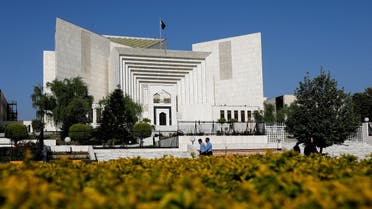  Police officers walk past the Supreme Court of Pakistan building, in Islamabad, Pakistan, on April 6, 2022. (Reuters)
