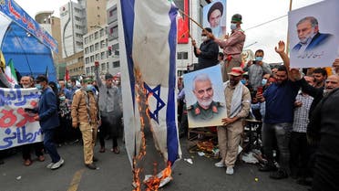 Iranians set an Israeli flag on fire during a rally marking Quds Day in the capital Tehran, on April 29, 2022. (AFP)