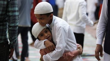 Boys greet each other after Eid al-Fitr prayers to mark the end of the holy fasting month of Ramadan, in Kathmandu, Nepal May 3, 2022. (Reuters)