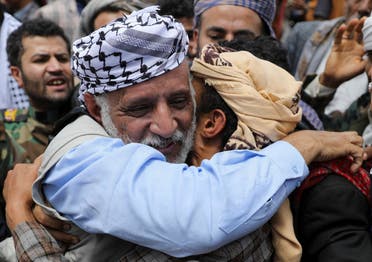 A relative embraces a freed prisoner upon his arrival on an International Committee of the Red Cross (ICRC)-chartered plane at Sanaa Airport, amid a prisoner swap between two sides in the Yemen conflict, in Sanaa, Yemen, on April 16, 2023. (Reuters)