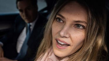 Greek MEP Eva Kaili smiles in the back of a vehicle arrives at her home in Brussels upon her release from Haren prison, in Brussels on April 14, 2023. (AFP)