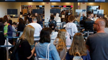 Passengers wait in line at Berlin Brandenburg Airport (BER), in Schoenefeld near Berlin, Germany, July 7, 2022. REUTERS/Michele Tantussi