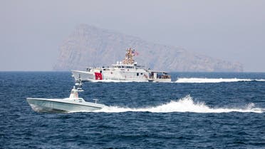 A US Navy L3 Harris Arabian Fox MAST-13 drone boat and the US Coast Guard cutter USCGC John Scheuerman transit the Strait of Hormuz on Wednesday, April 19, 2023. (US Coast Guard via AP)