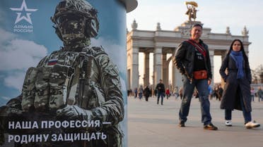 People walk past a desk promoting Russian army service in Moscow, Russia, on April 12, 2023. (Reuters)