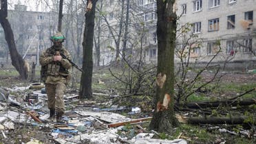 A Ukrainian service member walks near residential buildings damaged by a Russian military strike, amid Russia's attack on Ukraine, in the front line town of Bakhmut, in Donetsk region, Ukraine April 21, 2023. REUTERS/Anna Kudriavtseva