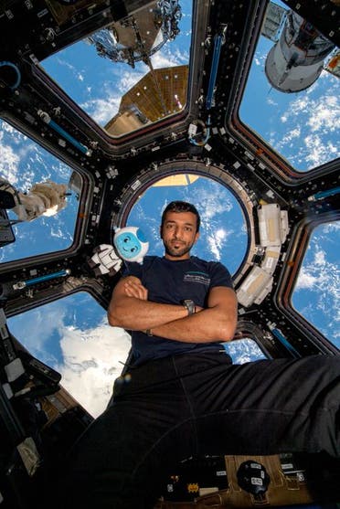 Emirati astronaut Sultan al-Neyadi has sent Eid al-Fitr greetings from space – alongside his mascot for the nation's space mission, his colorful stuffed toy Suhail. (Twitter)