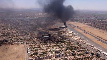 This image grab taken from AFPTV video footage on April 20, 2023, shows an aerial view of black smoke rising above the Khartoum International Airport amid ongoing battles between the forces of two rival generals. (AFP)