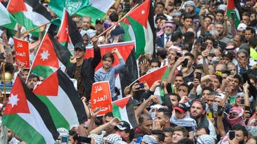 Demonstrators hold Palestinian and Jordanian flags as they attend a protest to support Al-Aqsa Mosque in Amman, Jordan on April 22, 2022. (Reuters)
