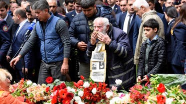 People lay flowers at the Tsitsernakaberd Armenian Genocide Memorial in Yerevan on April 24, 2023, to mark the 108th anniversary of World War I-era mass killings. (AFP)