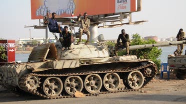 Sudanese army soldiers, loyal to army chief Abdel Fattah al-Burhan, sit atop a tank in the Red Sea city of Port Sudan, on April 20, 2023. (AFP)