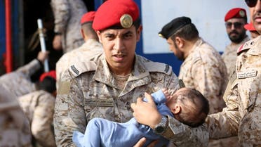 Saudi Navy personnel assist a child being evacuated by Saudi Arabia from Sudan to escape the conflicts, at Jeddah Sea Port, Jeddah, Saudi Arabia, April 26, 2023. (Reuters)