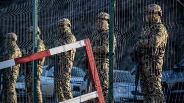 Azerbaijani servicemen stand guard at a checkpoint at the Lachin corridor, the Armenian-populated breakaway Nagorno-Karabakh region's only land link with Armenia, as Azerbaijani environmental activists protest against what they claim the illegal mining, on December 27, 2022.(AFP)