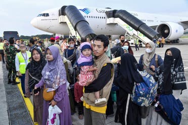 This handout picture taken and released on April 28, 2023 by the Indonesian Foreign Ministry shows the first group of Indonesians evacuated from strife-torn Sudan arriving at Soekarno-Hatta International airport in Jakarta after a chartered flight from Saudi Arabia. (AFP)