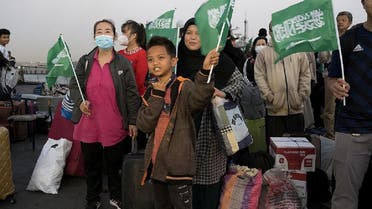 Civilians of different nationalities wave Saudi flags after being evacuated by Saudi Arabia from Sudan to escape the conflicts, upon their arrival at Jeddah Sea Port, in Jeddah, Saudi Arabia, on April 27, 2023. (Reuters)
