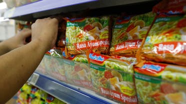 A worker arranges Indomie Special Chicken Flavour instant noodles packets, produced by PT Indofood Sukses Makmur, on the shelves of a supermarket in Jakarta, Indonesia April 26, 2023. (Reuters)