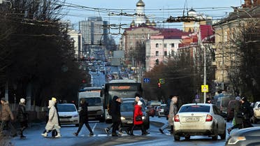Pedestrians cross Lenin street, named after the Soviet State founder Vladimir Ilyich Lenin, in Bryansk on March 3, 2023. (AFP)