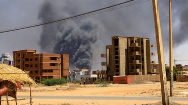 A man walks while smoke rises above buildings after aerial bombardment, during clashes between the paramilitary Rapid Support Forces and the army in Khartoum North, Sudan, May 1, 2023. REUTERS/Mohamed Nureldin Abdallah TPX IMAGES OF THE DAY