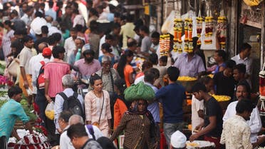 People walk through a crowded market in Mumbai, India. (Reuters)